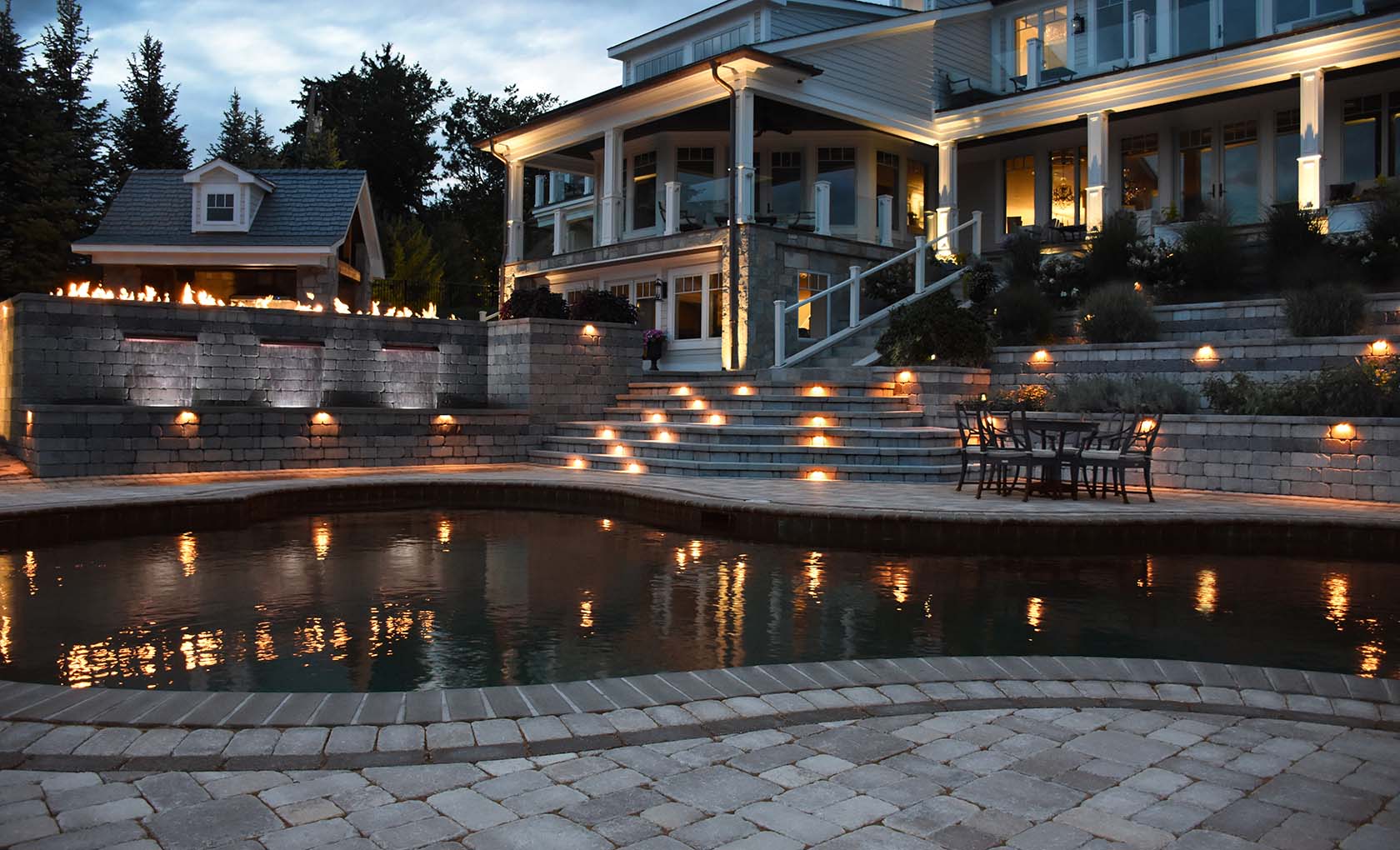 high end home with pool and custom concrete stepped patio